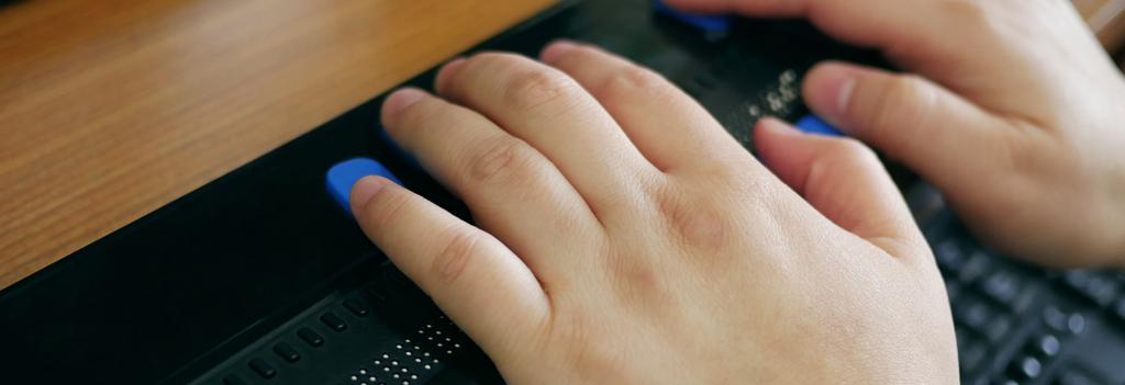 hands using braille keyboard
